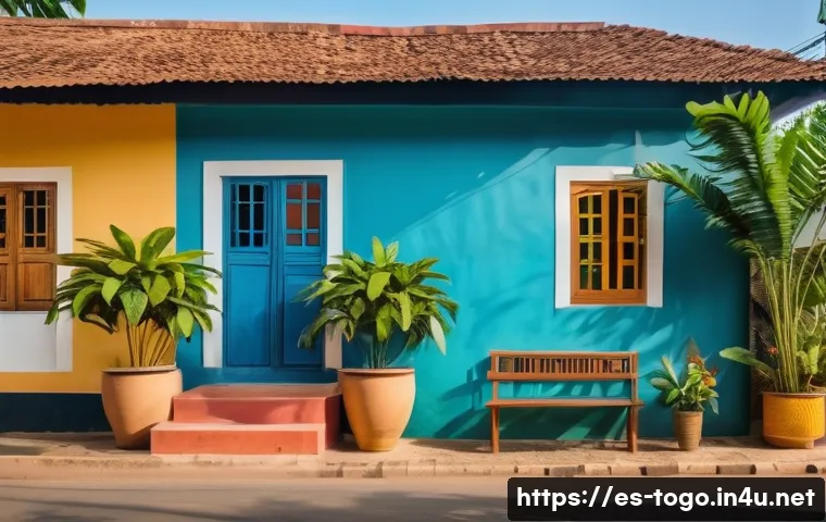 토고의 저렴한 게스트하우스 - A cozy guesthouse exterior in Lomé, Togo, featuring a charming, colorful facade with traditional Wes...